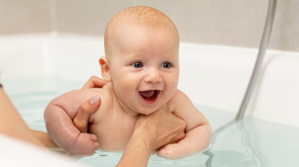 close-up parent washing happy baby